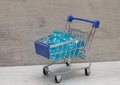 shopping cart filled with blue hearts made of glass