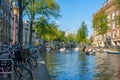 Lots of Boats on the Amsterdam Canal and Bikes on the Banks Royalty Free Stock Photo