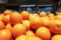 Lots of bright juicy oranges on the counter. Seasonal fruits. Healthy eating and vegetarianism Royalty Free Stock Photo