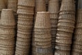 Lots of brown woven baskets made from natural rattan. Stacks of natural rattan baskets are displayed