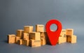 Lots of cardboard boxes and a red position pin. Locating packages and goods. Algorithm for constructing a minimum route