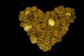 Lots coin gold Arranged in heart shape on black background texture, Investment and saving concept, Money stack for business Royalty Free Stock Photo