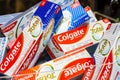 Lots of Colgate Total teeth whitening fluoride toothpaste packages, object closeup, nobody. Selling medical teeth care products