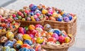 Lots of colorful handmade Easter eggs in multiple baskets, set of many traditional handcrafted Polish pisanki, festival market