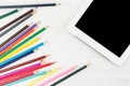 Lots Of Colorful Pencils NExt To Big Screen Tablet On White Wood Royalty Free Stock Photo