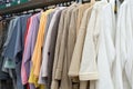 Lots of colorful women`s and men`s robes on hangers close-up Royalty Free Stock Photo