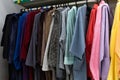 Lots of colorful women`s and men`s robes on hangers close-up Royalty Free Stock Photo