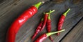 Lots of different chili peppers on the table. two kinds of hot peppers on a wooden table. Red hot peppers. Red hot Royalty Free Stock Photo