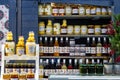 Lots of different colorful honey jars bottles, various honey containers, store, market stall, nobody. Healthy eco food, different