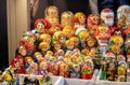 Lots of different colorful traditional Matryoshka stacking dolls on sale, group of objects, closeup. Traditional festive market