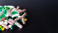 Lots of different medicine drugs, pills, tablets, capsules on black matte background. macro photo with selective focus. Medical