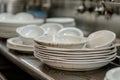 lots of dirty white plates in restaurant