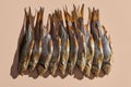 Lots of dried or jerky salty roach, palatable clipfish on pink background. Famous beer snack. Traditional way of