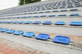 Lots of empty seats in the stadium. Texture of blue chairs. Plastic seats are arranged in a row. Dirty and scratched fan seats. St Royalty Free Stock Photo