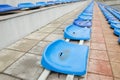 Lots of empty seats in the stadium. Texture of blue chairs. Plastic seats are arranged in a row. Dirty and scratched fan seats. St Royalty Free Stock Photo