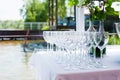 Lots of empty wine glasses on a festive white table. Buffet in nature in summer