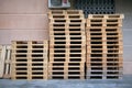 Lots of empty wooden pallets near a store or shopping center