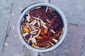 Trash can with cigarette residue and filters Royalty Free Stock Photo