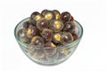 Lots of fresh ripe peeled longan fruits or dragon eye fruits in a glass bowl