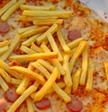 fries over the tasty pizza with wurstel mozzarella and tomato Royalty Free Stock Photo