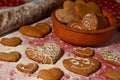 Lots of gingerbread in the shape of a heart on a flour and bowl with cookies