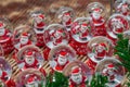 Lots of glass balls with Santa Claus and Christmas candy inside snow, fair, market Royalty Free Stock Photo