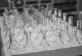 Lots of glass bottles. Clear glass bottles in the box. Empty glass bottles on the shelf Royalty Free Stock Photo