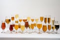 Lots of glasses of different beer on a white background