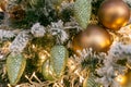 Lots of golden Christmas balls and Christmas cones on the Christmas tree. Close-up. Christmas decorations. Festive Christmas toys