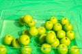 Lots of green apples in the water with splashes on a dark green background in a transparent container Royalty Free Stock Photo