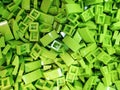 Lots of green plastic items from the designer. Toy identical bricks for children's creativity