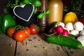 A lots of healthy vegetables on a wooden table, heart