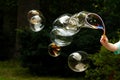Lots Of Huge Soap Bubbles Floating In The Air In The Garden, Child Blowing Many Big Bubbles In The Backyard, Outside, Outdoors
