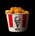 A lots of KFC chicken hot wings or strips in bucket of KFC Kentucky Fried Chicken fast food