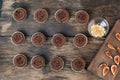 Lots of little chocolate cupcakes on wooden table. Mafins from chocolate dough will be decorated with pieces of figs and ground Royalty Free Stock Photo