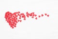 Lots of little red hearts flying on white background.