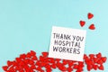 Lots of little red hearts and the inscription Thank you to hospital workers on a blue background