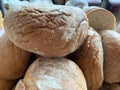 Lots of loaves of bread on the table. Concept: baking wheat to help people. Bread whole and cut into halves