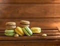 Lots of Macaroons cookies of different colors, on a wooden background