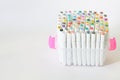 Lots of multi-colored numbered felt-tip pens or drawing markers in clear plastic box or case. White background. Concept of tools Royalty Free Stock Photo