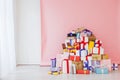 Lots of multicolored birthday presents New Year Christmas on a pink background