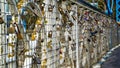 Lots of padlocks locked to a bridge railing as romantic gestures