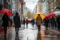 Lots of people with umbrellas and waterproof clothing. Street view on a rainy autumn day