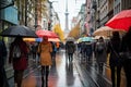 Lots of people with umbrellas and waterproof clothing. Street view on a rainy autumn day