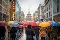 Lots of people with umbrellas and waterproof clothing. Street view on a rainy autumn day