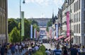 Lots of people walking down the main street Karl Johans gate in the center of Oslo, Norway