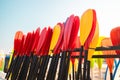 Lots of plastic colored paddles in storage on the beach. Active family summer vacation time sports. Close up