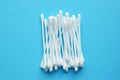 Lots of plastic cotton swabs on a blue background