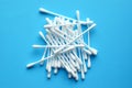 Lots of plastic cotton swabs on a blue background