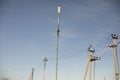 Lots of poles with wires. Electrical wires against sky. Royalty Free Stock Photo